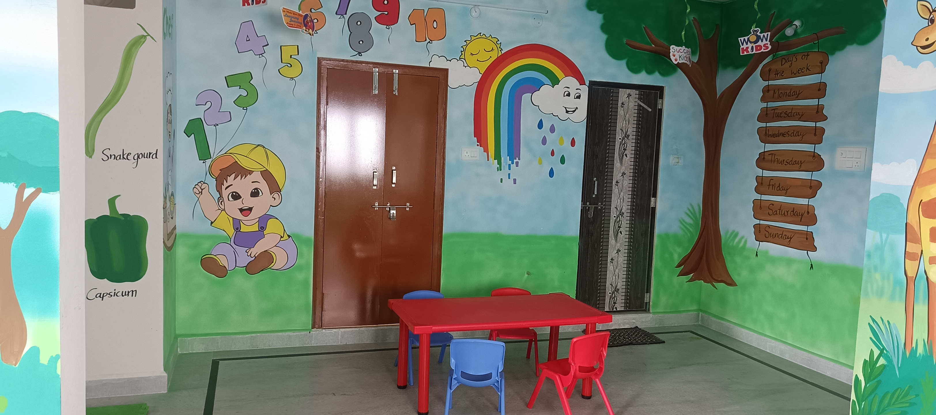 Indoor play zone with rainbow swing bridge, slides and colourful ball pit in the background