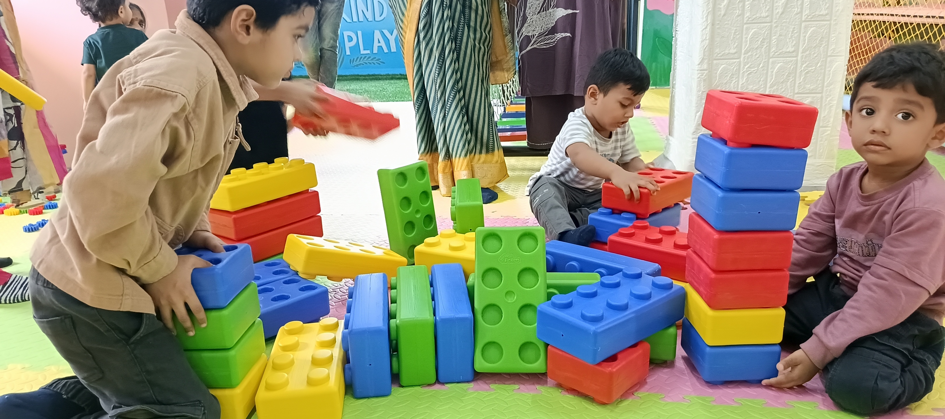 Children focusing on motor skills block building